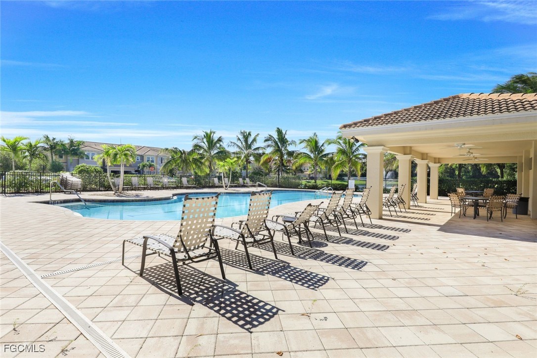 a view of swimming pool with outdoor seating and plants