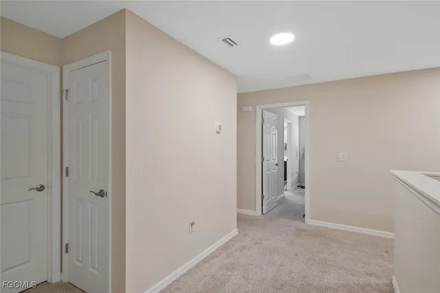 a view of an empty room with closet area