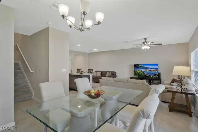 a living room with furniture and chandelier