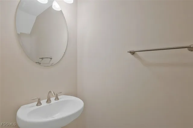 a bathroom with a sink and mirror