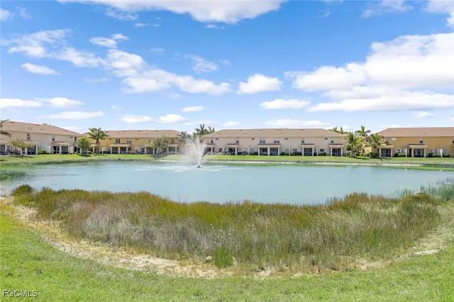 a view of a lake with houses in the back