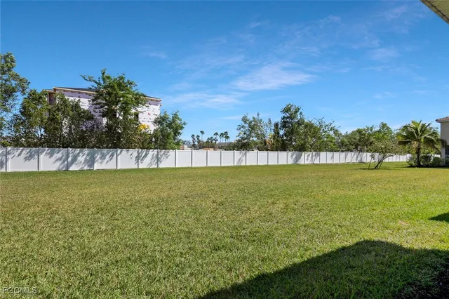 a view of yard with swimming pool and green space