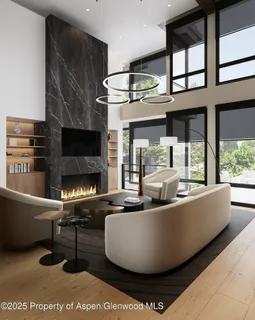 a living room with furniture a fireplace and a large window