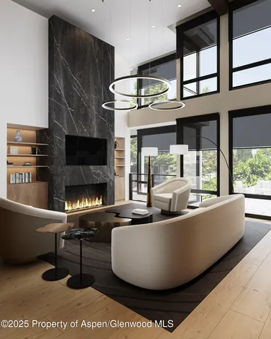 a living room with furniture a fireplace and a large window