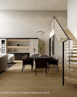 a living room with furniture a rug and a painting on the wall