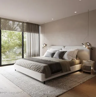 a bedroom with a large bed and a large window