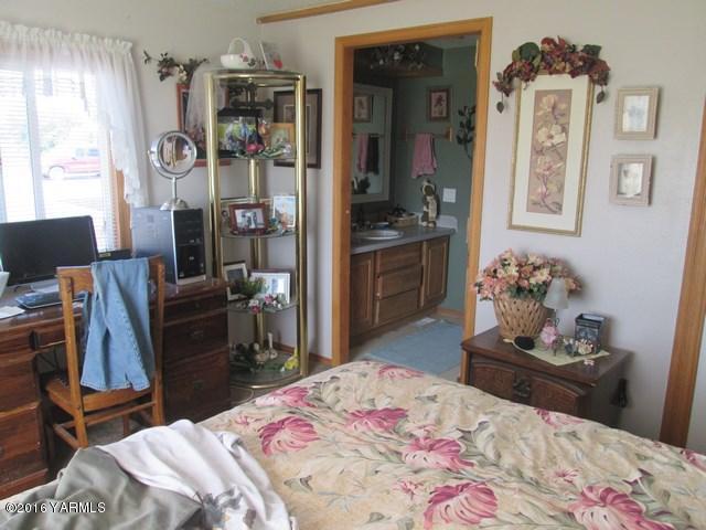120751 Heck Road Prosser, WA 99350 - Photo 11 of 27 a bedroom with a bed and wooden floor