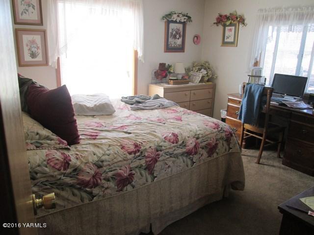 120751 Heck Road Prosser, WA 99350 - Photo 9 of 27 a bedroom with a bed and wooden floor