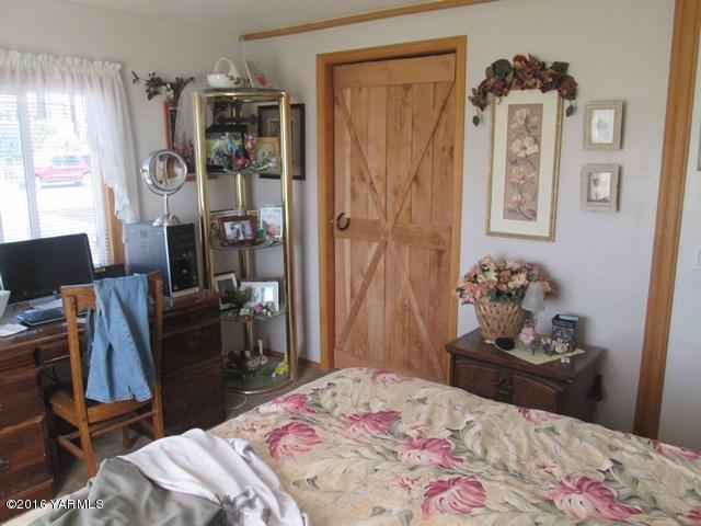 120751 Heck Road Prosser, WA 99350 - Photo 10 of 27 a bedroom with a bed and wooden floor