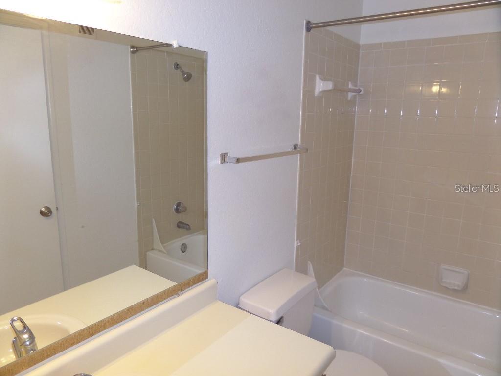 1065 South Hiawassee Road, Unit 1417 Orlando, FL 32835 - Photo 2 of 13 a bathroom with a bathtub and a shower