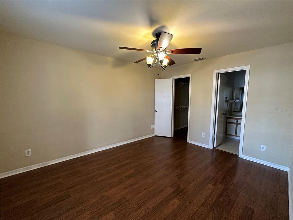 1065 South Hiawassee Road, Unit 1417 Orlando, FL 32835 - Photo 7 of 13 a view of a room with wooden floor and ceiling fan