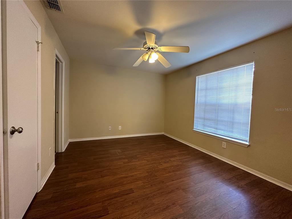 1065 South Hiawassee Road, Unit 1417 Orlando, FL 32835 - Photo 9 of 13 a view of an empty room with wooden floor and a window