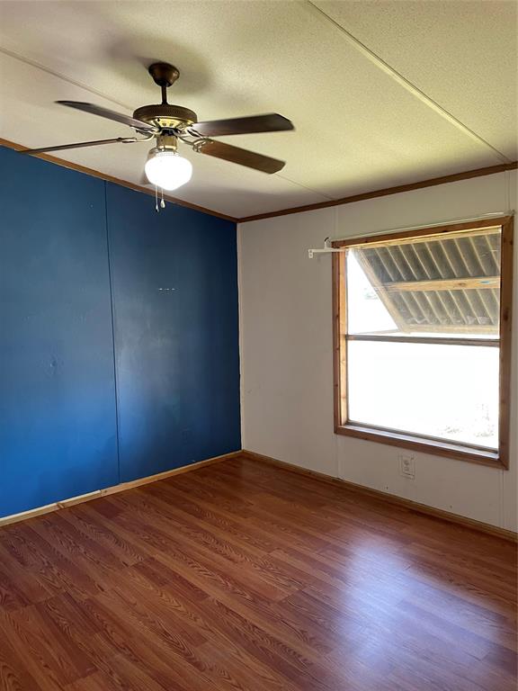 369 Private Road, Unit 4521 Wolfe City, TX 75496 - Photo 14 of 23 a view of a livingroom with a window and wooden floor