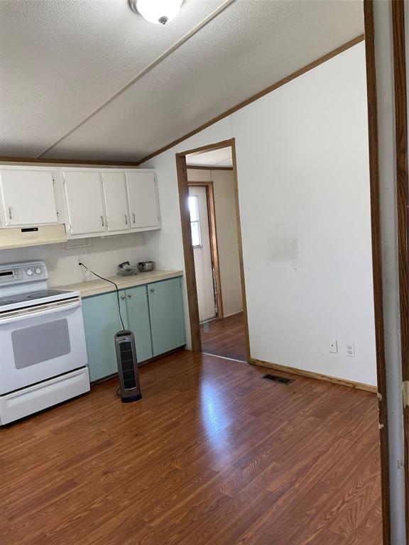 369 Private Road, Unit 4521 Wolfe City, TX 75496 - Photo 18 of 23 a view of a kitchen with wooden floor and electronic appliances