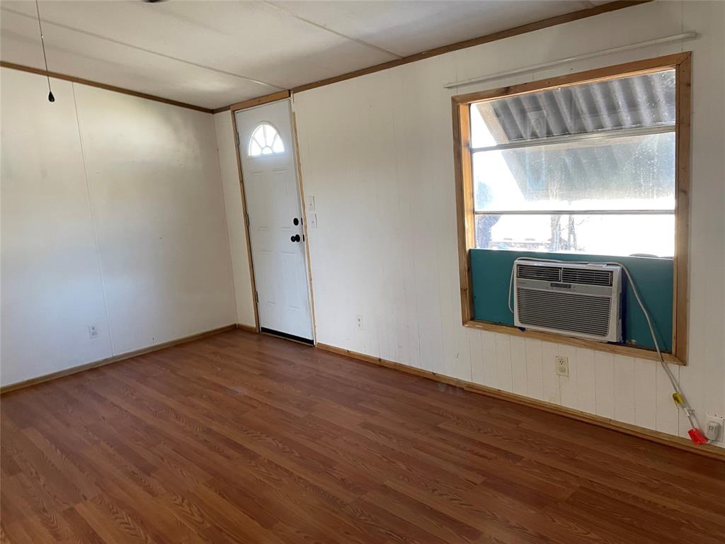 369 Private Road, Unit 4521 Wolfe City, TX 75496 - Photo 19 of 23 a view of an empty room with wooden floor and a window