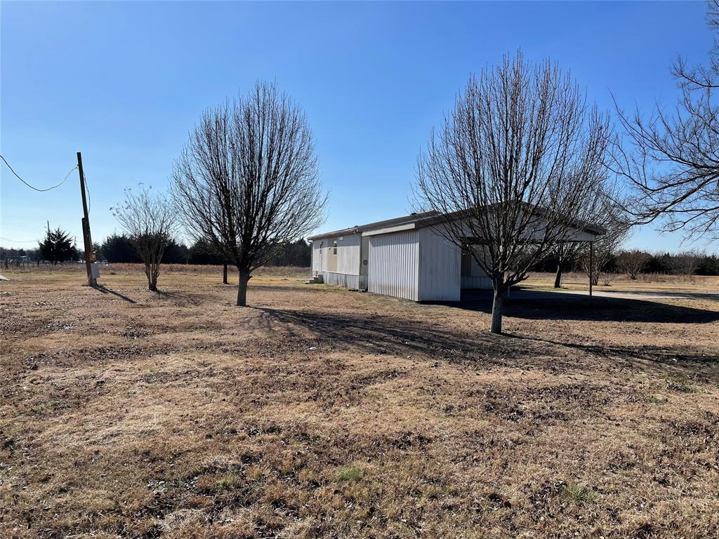 369 Private Road, Unit 4521 Wolfe City, TX 75496 - Photo 2 of 23 a view of a yard with wooden fence