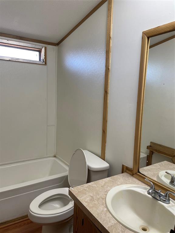 369 Private Road, Unit 4521 Wolfe City, TX 75496 - Photo 10 of 23 a bathroom with a granite countertop toilet sink and mirror