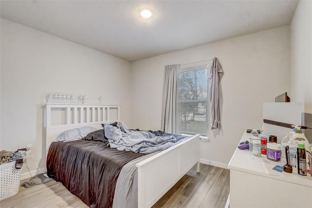 5 Rainbow Lane Palm Coast, FL 32164 - Photo 11 of 16 a bedroom with a bed and a dresser next to a window