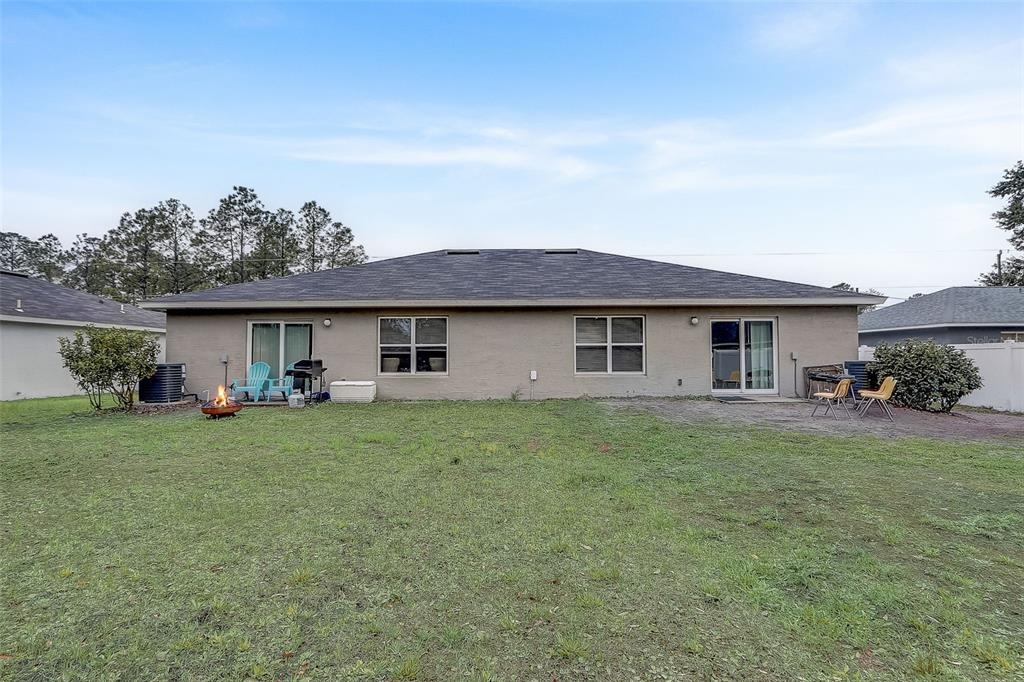 5 Rainbow Lane Palm Coast, FL 32164 - Photo 13 of 16 front view of a house with a garden