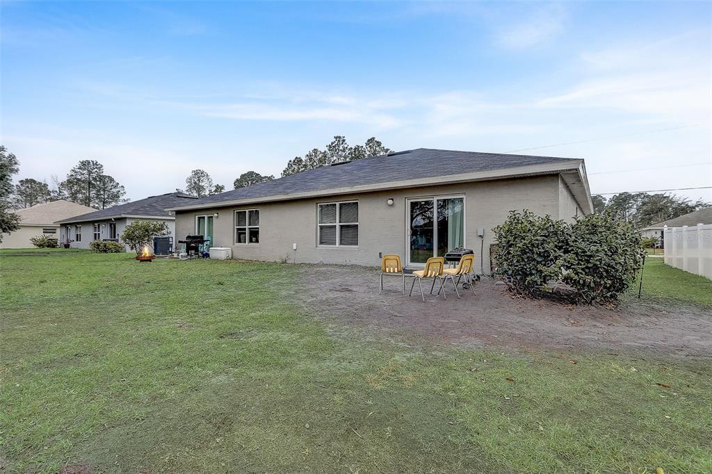5 Rainbow Lane Palm Coast, FL 32164 - Photo 14 of 16 a view of a house with a backyard