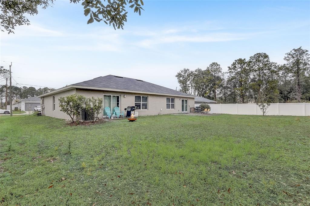 5 Rainbow Lane Palm Coast, FL 32164 - Photo 15 of 16 a view of a house with a big yard