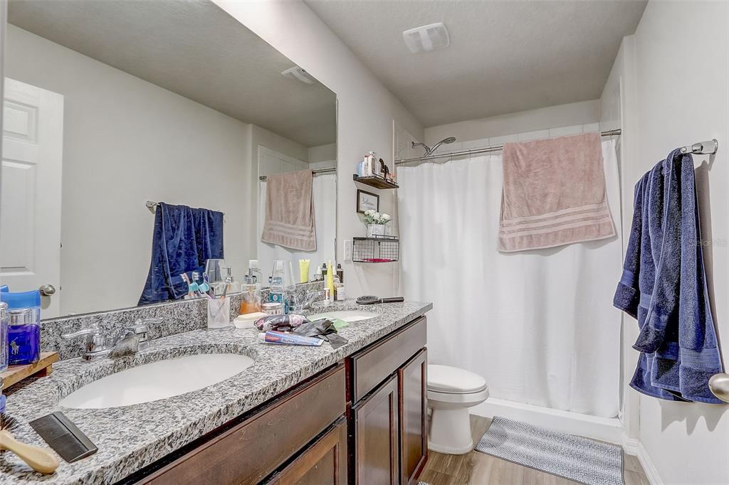 5 Rainbow Lane Palm Coast, FL 32164 - Photo 10 of 16 a bathroom with a granite countertop sink toilet and shower