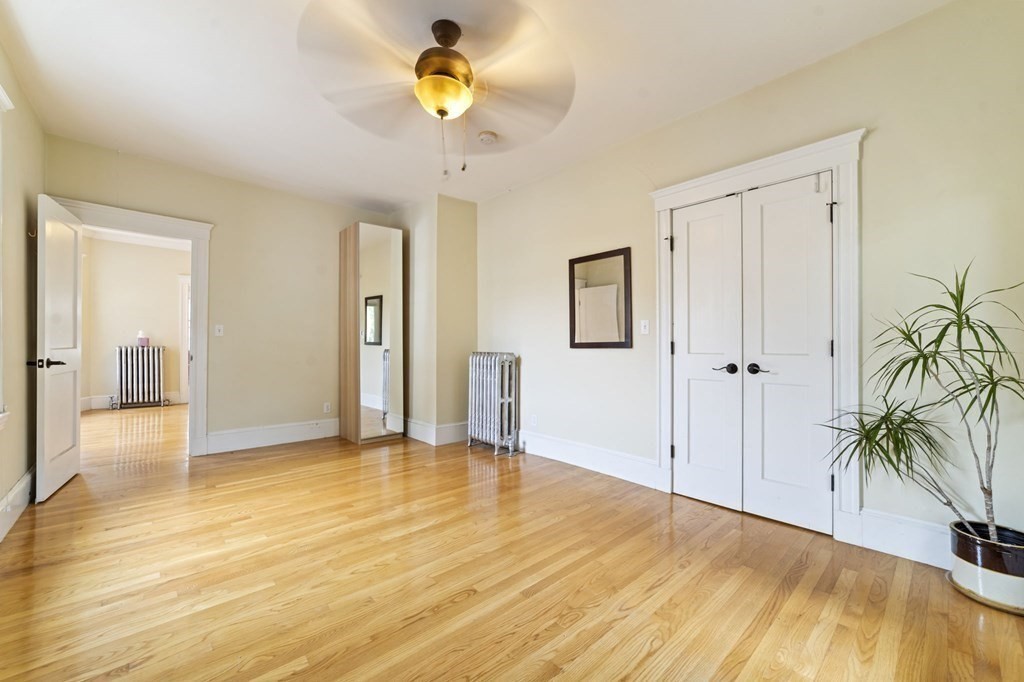 81 Montebello Road, Unit 3 Boston, MA 02130 - Photo 13 of 20 a view of empty room with wooden floor and fan