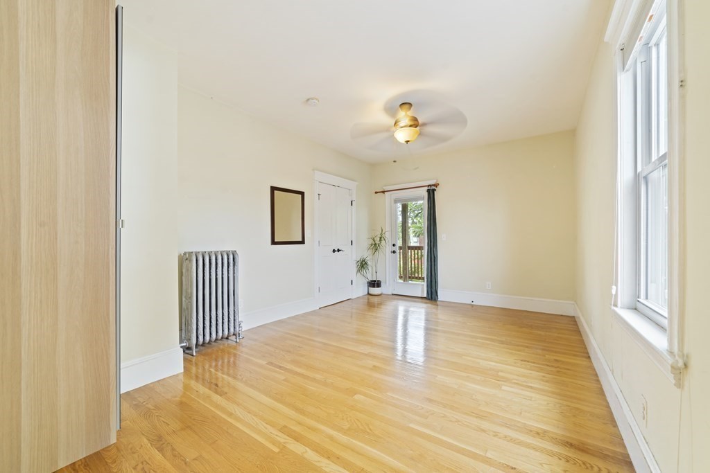 81 Montebello Road, Unit 3 Boston, MA 02130 - Photo 14 of 20 a view of an empty room with wooden floor and a window