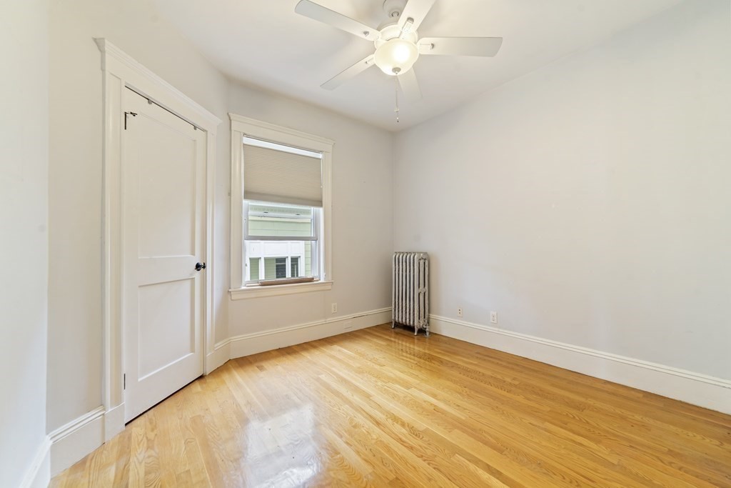 81 Montebello Road, Unit 3 Boston, MA 02130 - Photo 16 of 20 a view of an empty room with wooden floor and a window