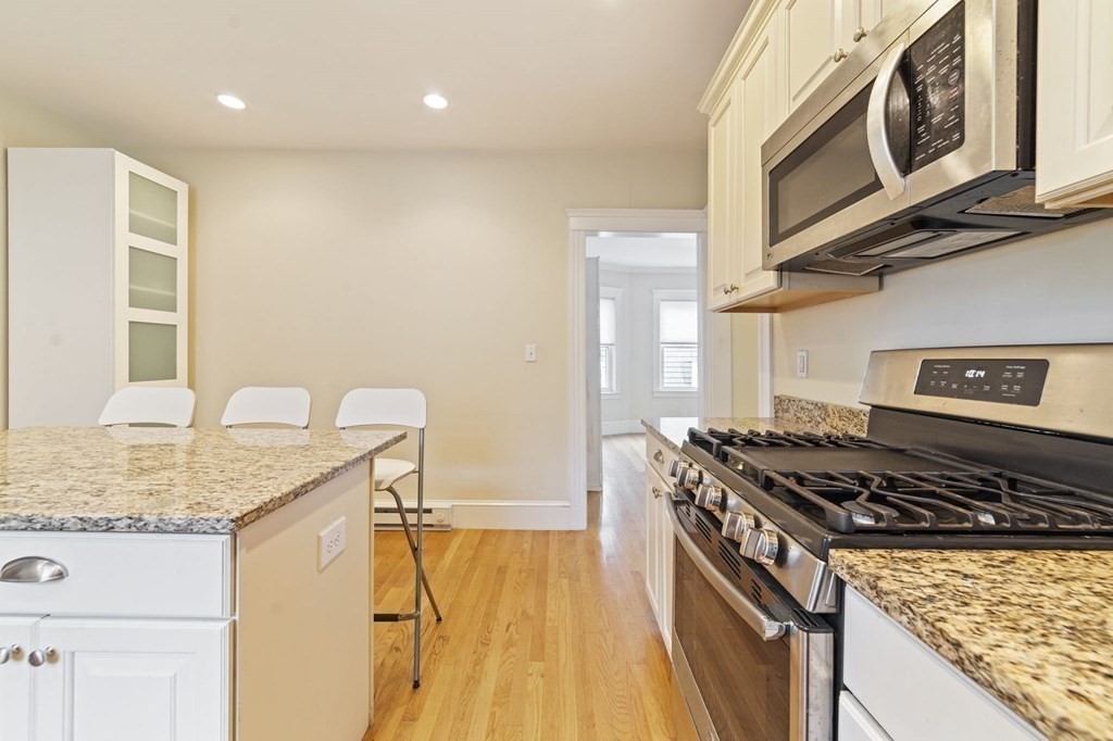 81 Montebello Road, Unit 3 Boston, MA 02130 - Photo 8 of 20 a kitchen with stainless steel appliances granite countertop a stove and a sink