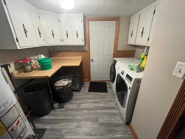 a utility room with fridge and washer