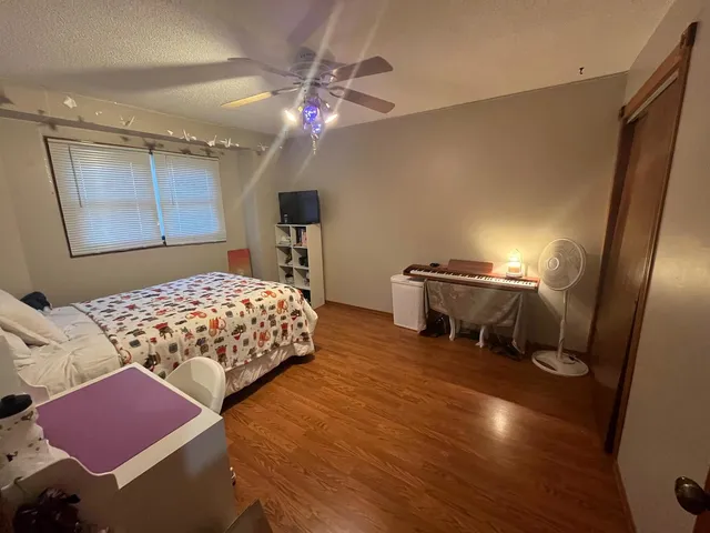 a bedroom with bed and a chandelier
