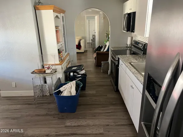 a kitchen with sink a refrigerator and chairs