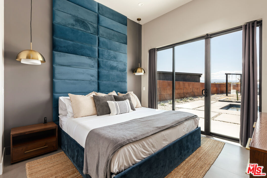 3000 Rockwood Road Joshua Tree, CA 92252 - Photo 57 of 71 a bedroom with a bed and a large window