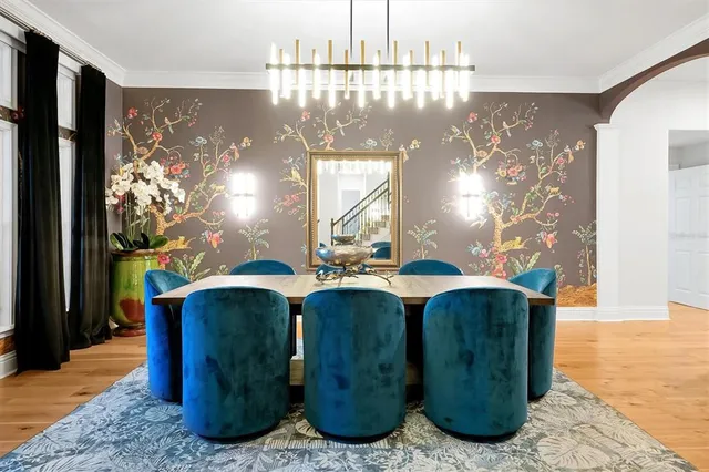 a bedroom with a large bed and a chandelier