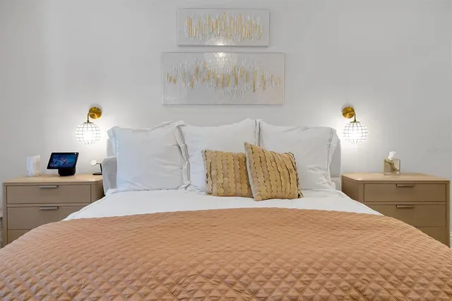 a bedroom with a bed and a chandelier