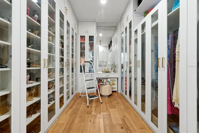 a view of a garage with refrigerator and a car parked