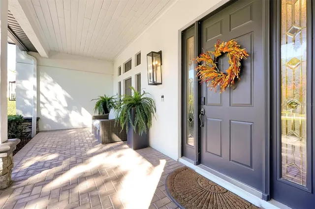 a living room with furniture wooden floor and a large window