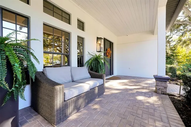 a kitchen with kitchen island granite countertop a sink cabinets and wooden floor