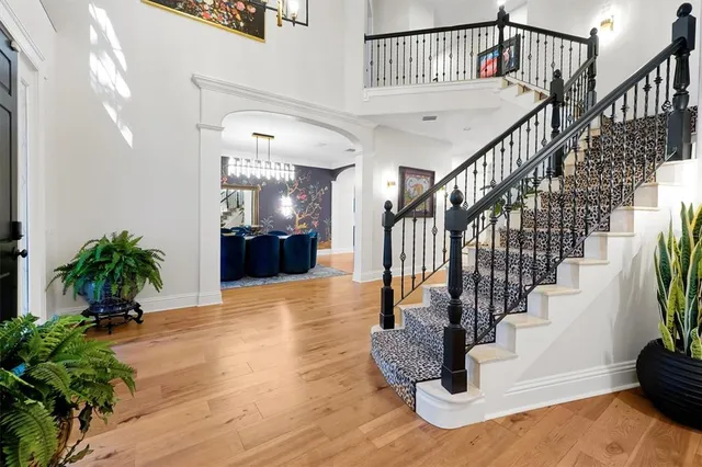 a kitchen with stainless steel appliances a sink cabinets and wooden floor