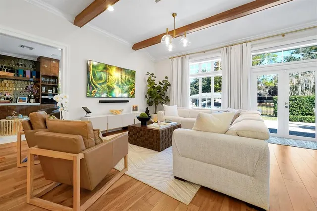 a kitchen with stainless steel appliances a stove a sink dishwasher and white cabinets with wooden floor