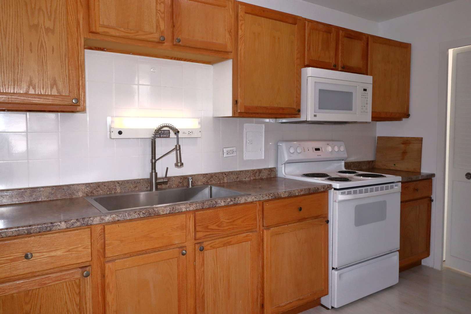 5701 North Sheridan Road, Unit 6P Chicago, IL 60660 - Photo 13 of 20 a kitchen with granite countertop cabinets stainless steel appliances and a sink