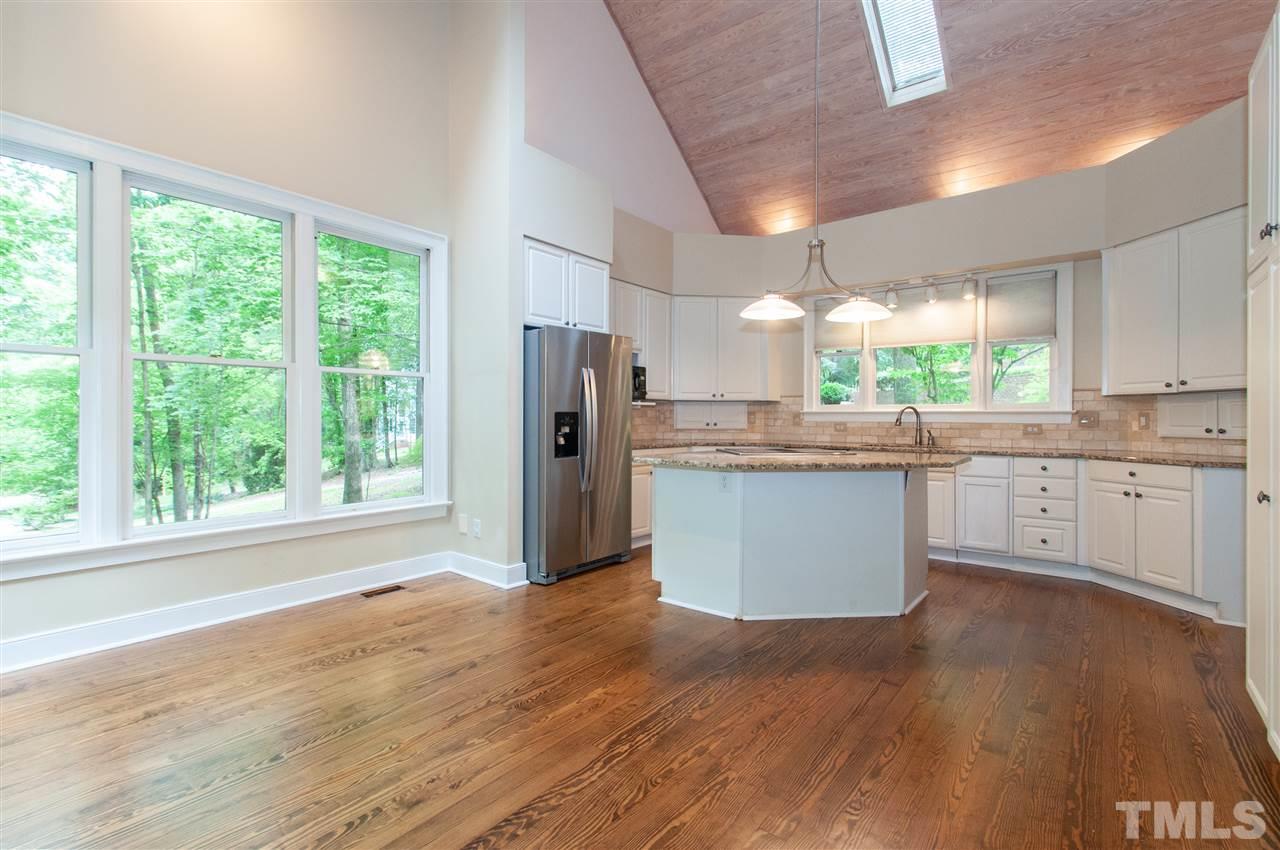 1700 Percheron Place Raleigh, NC 27613 - Photo 12 of 30 a kitchen with stainless steel appliances granite countertop a refrigerator a sink dishwasher a stove and white countertops with wooden floor