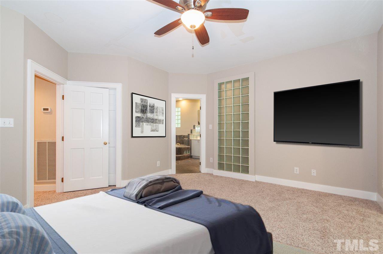 1700 Percheron Place Raleigh, NC 27613 - Photo 14 of 30 a bedroom with a bed and a flat screen tv