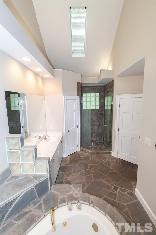 1700 Percheron Place Raleigh, NC 27613 - Photo 19 of 30 a large bathroom with a tub and shower