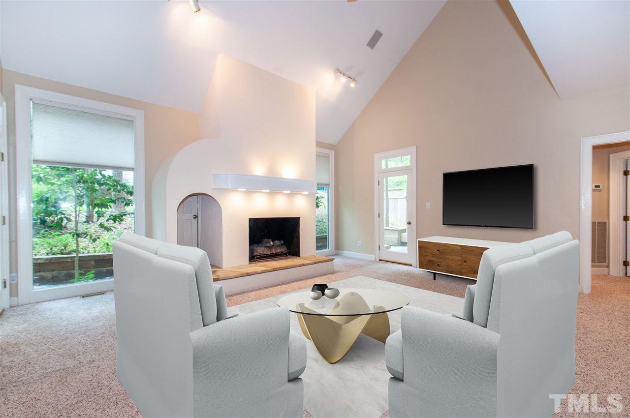 1700 Percheron Place Raleigh, NC 27613 - Photo 4 of 30 a living room with furniture a flat screen tv and a fireplace