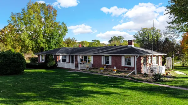 a front view of a house with a yard table and chairs