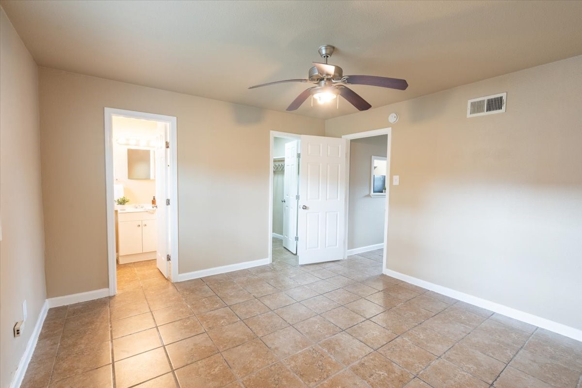 1907 Dismuke Street, Unit 32 Houston, TX 77023 - Photo 6 of 8 an empty room with closet and a chandelier fan