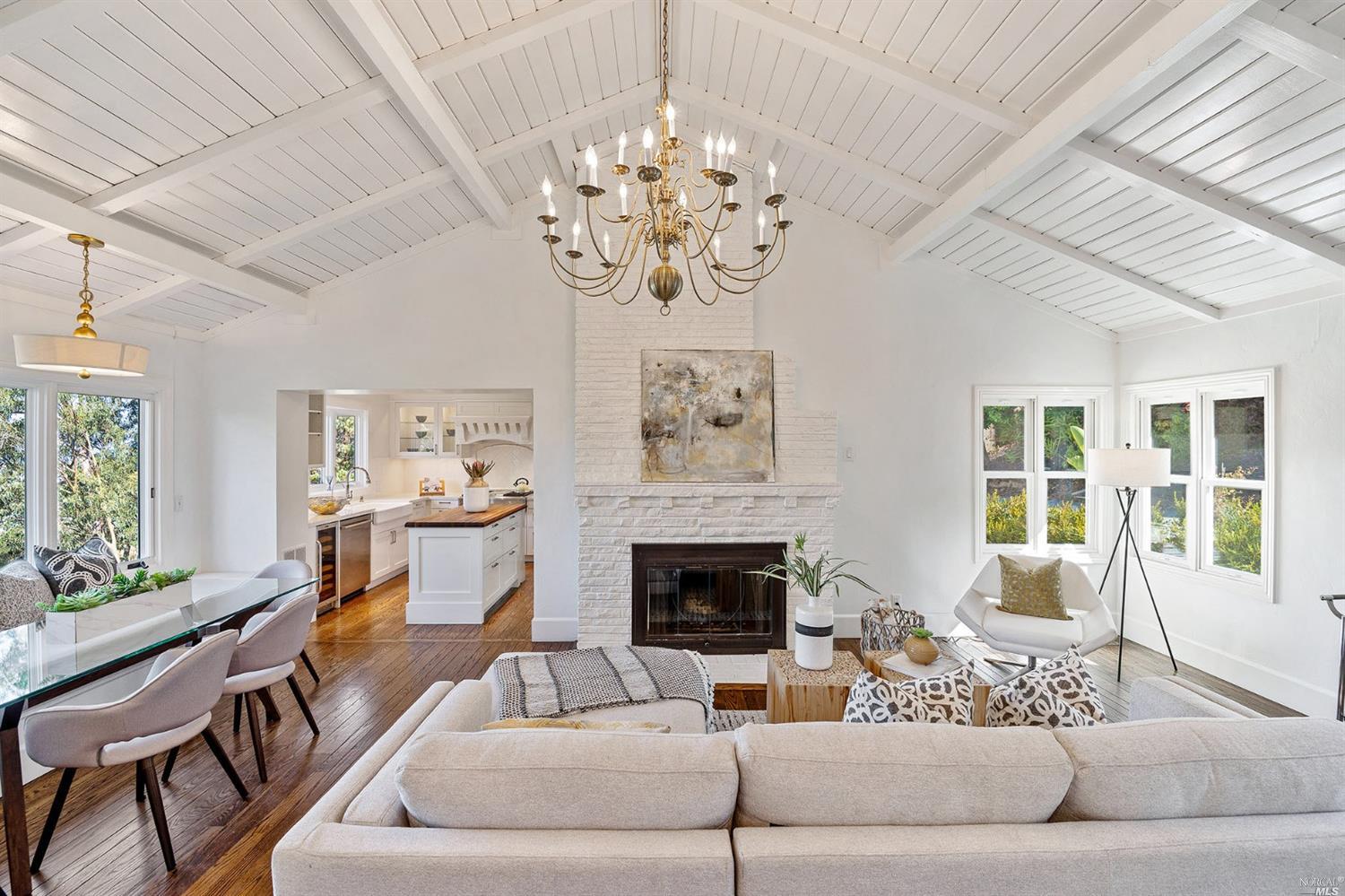 374 Elm Avenue Larkspur, CA 94939 - Photo 1 of 1 a living room with furniture a chandelier and a fireplace