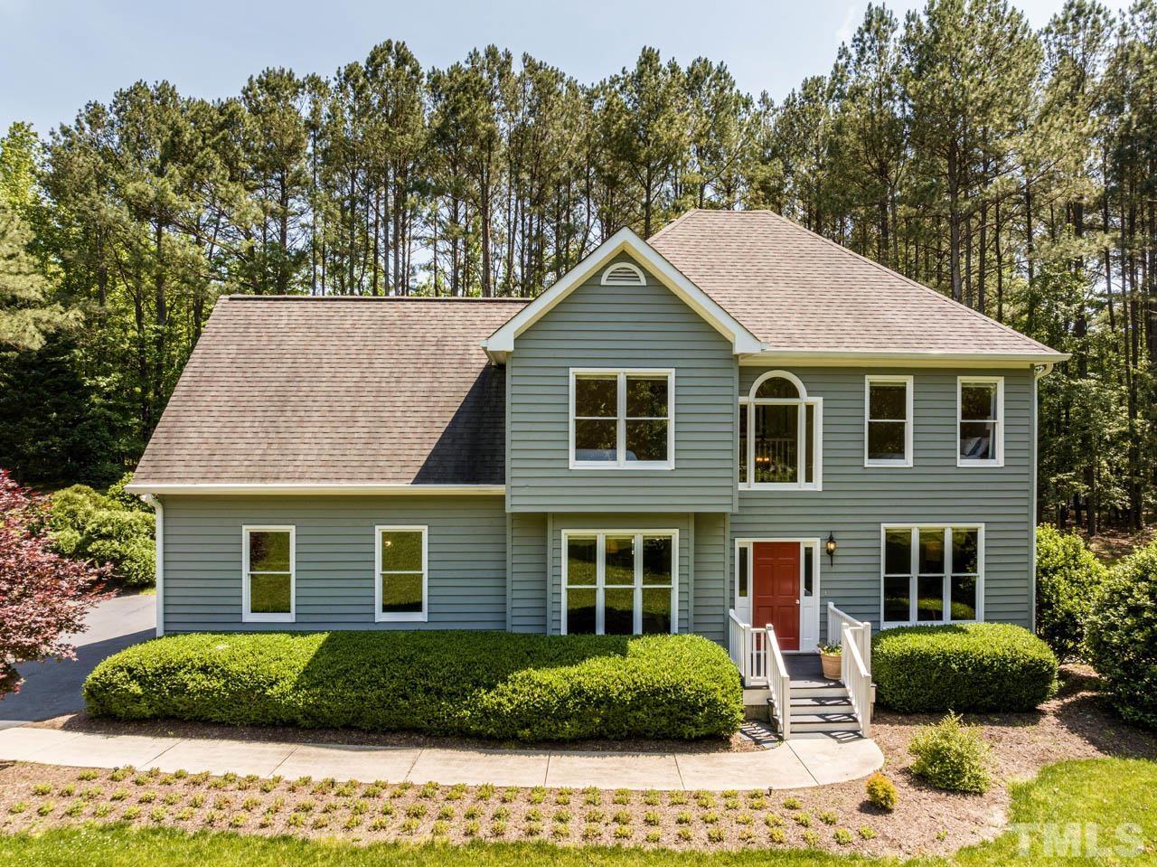 325 Morris Road Pittsboro, NC 27312 - Photo 1 of 39 a view of a yard in front of a house with plants and large tree